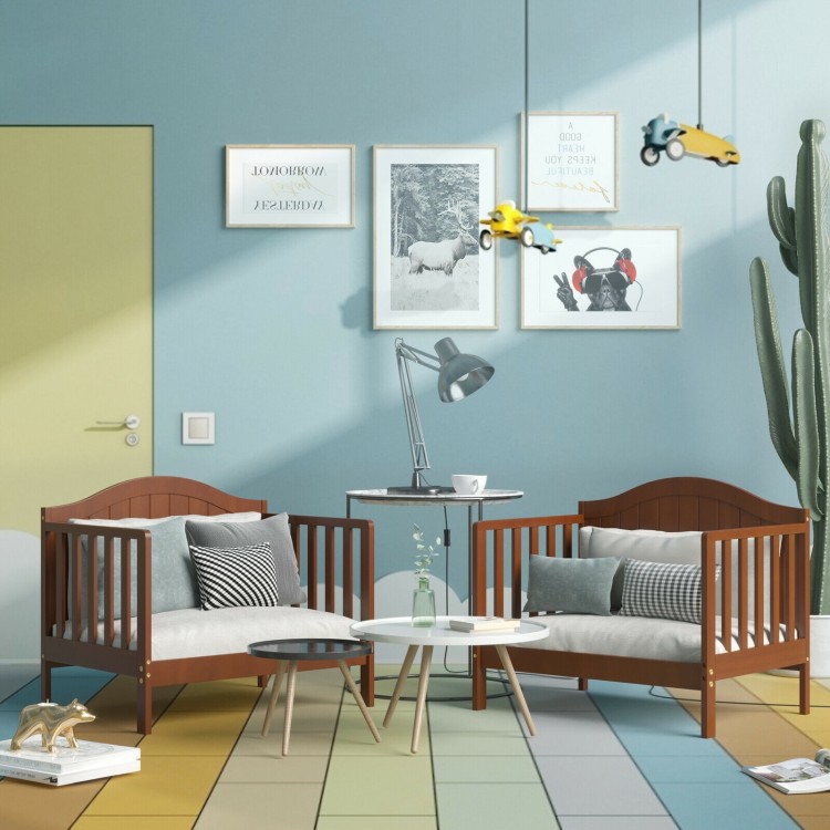 Classic convertible wooden toddler bed in brown with guardrails, transforms into two kids' chairs for versatile use.
