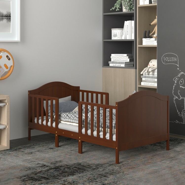 Classic brown toddler bed with guardrails, made of rubberwood, converts into two chairs for versatile kids' furniture.