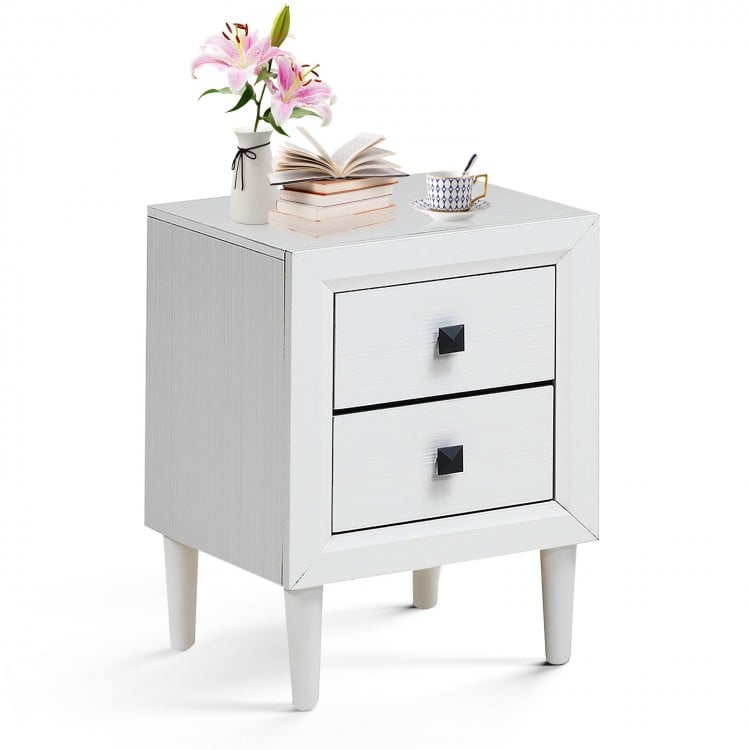 White bedside nightstand with a sleek design and two spacious drawers, ideal for enhancing any room's decor.