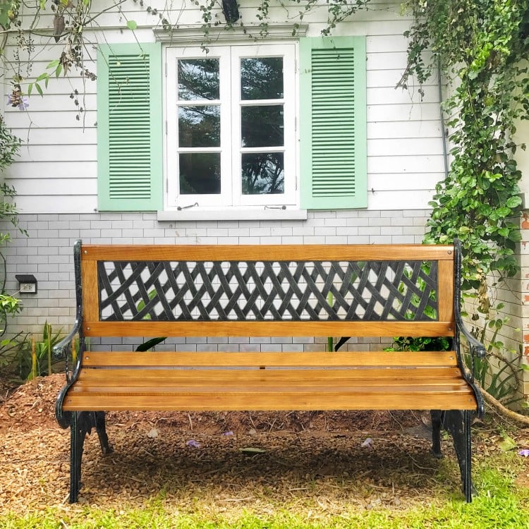 Outdoor cast iron patio bench with solid wood seat and PVC backrest, perfect for garden seating and stability.