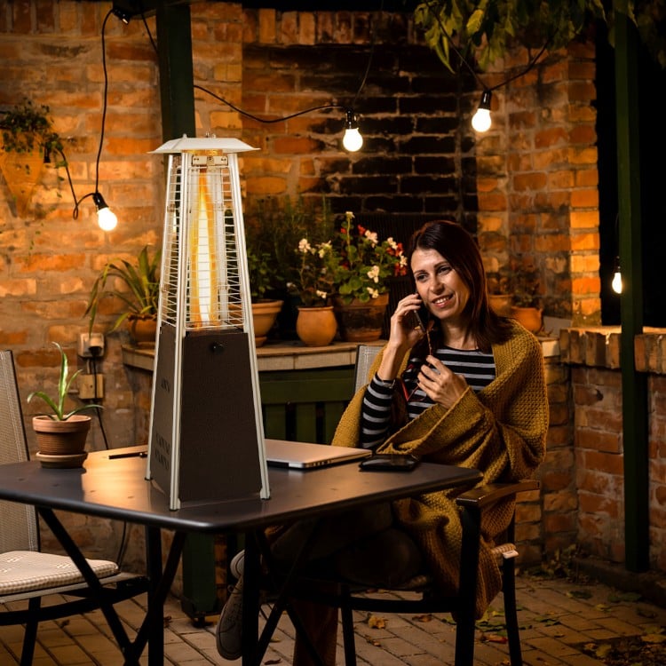 Portable steel tabletop patio heater with glass tube, 10000 BTU, providing 360° heat for outdoor gatherings.
