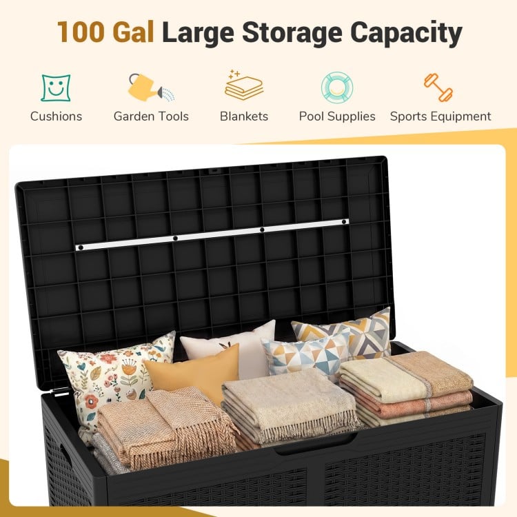 Large black 100-gallon resin deck box with cushions and blankets, ideal for outdoor waterproof storage and seating.