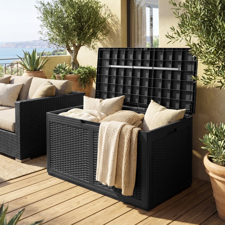 Black 100-gallon resin deck box with rattan texture, open lid showing blankets, ideal for outdoor storage and seating.