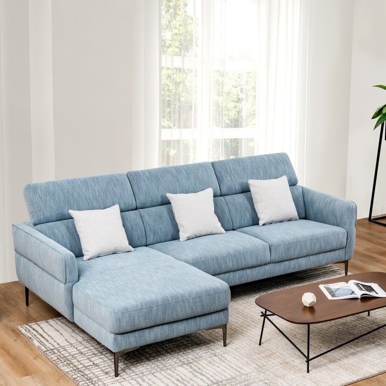 Blue L-shaped sofa couch with spacious chaise, adjustable headrests, and cozy cushions for ultimate relaxation in.