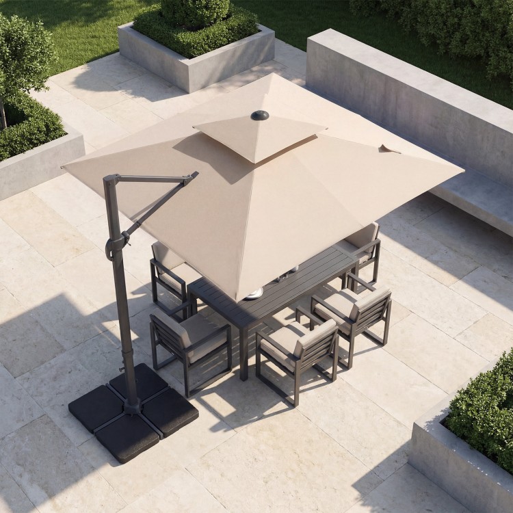 10 FT beige aluminum cantilever umbrella with 220 lbs base, providing shade for outdoor dining set on patio.