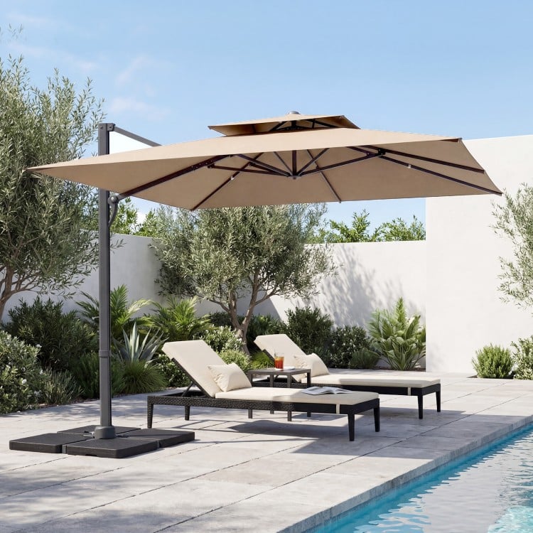 10 FT cantilever umbrella with aluminum pole and 220 lbs base, providing shade for outdoor lounging by the pool.