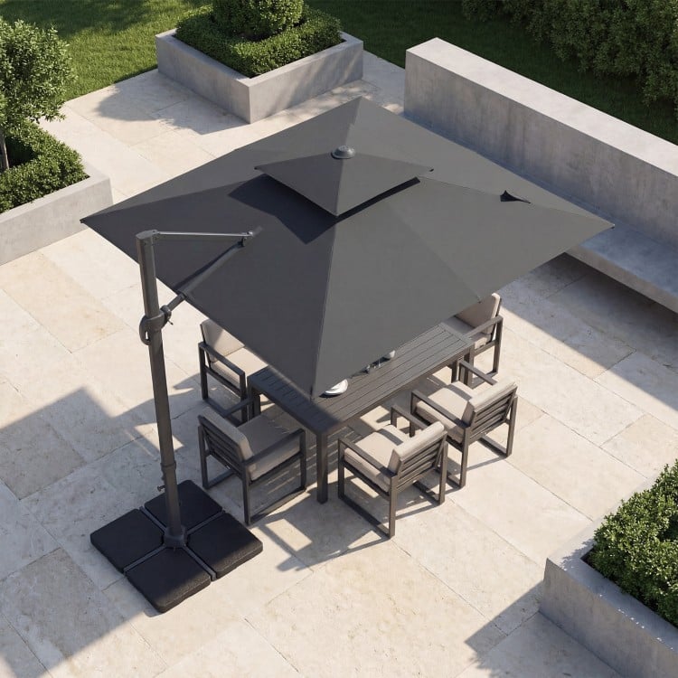 10 FT gray cantilever umbrella with aluminum pole and 220 lbs base, providing shade for outdoor dining area.