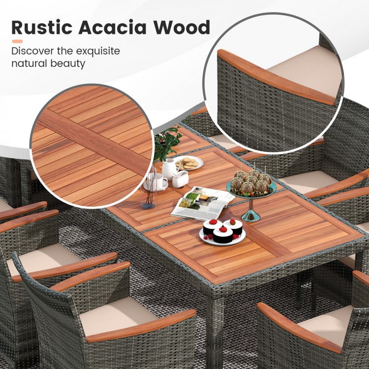 Close-up of the rustic acacia wood tabletop and armrests on a gray wicker dining set for outdoor gatherings.