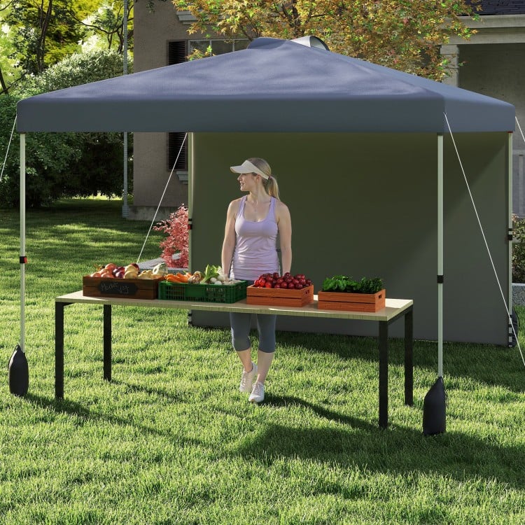 Pop-up 10x10 ft gray canopy tent with sidewall, set up for outdoor use, featuring a sturdy frame and sun protection.