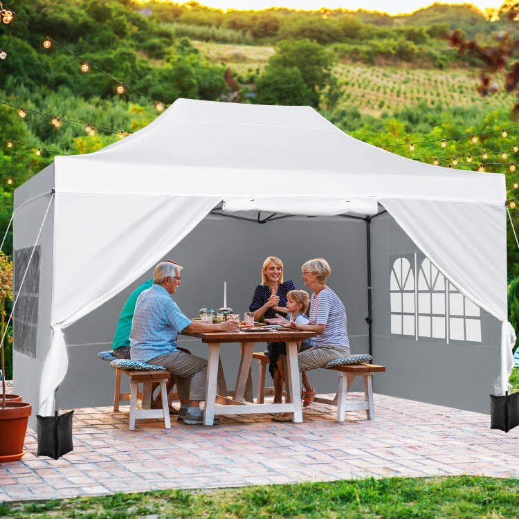 Pop up canopy tent with sidewalls and windows, providing sunshade for outdoor gatherings and events.