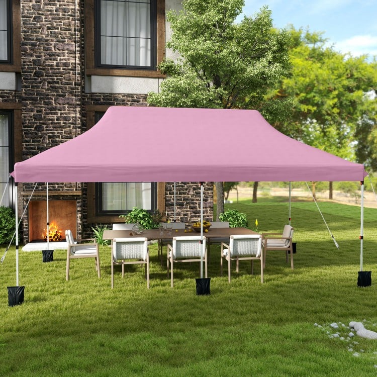 Pink 10 x 20 ft pop-up canopy tent set up in a garden, providing ample shade for outdoor gatherings and events.