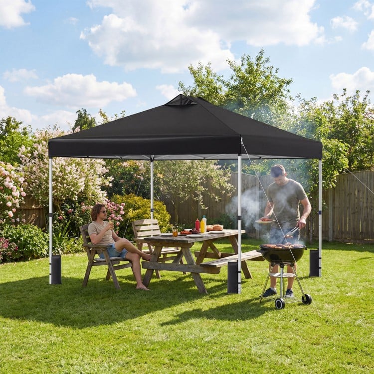 Black 10 x 10 feet outdoor pop-up canopy tent with sturdy steel frame, providing shade for outdoor activities.