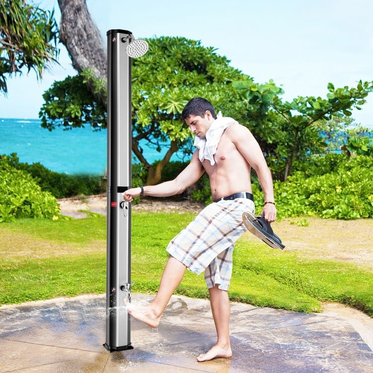 Solar heated shower with adjustable head and foot tap, perfect for outdoor use and cooling off on hot days.
