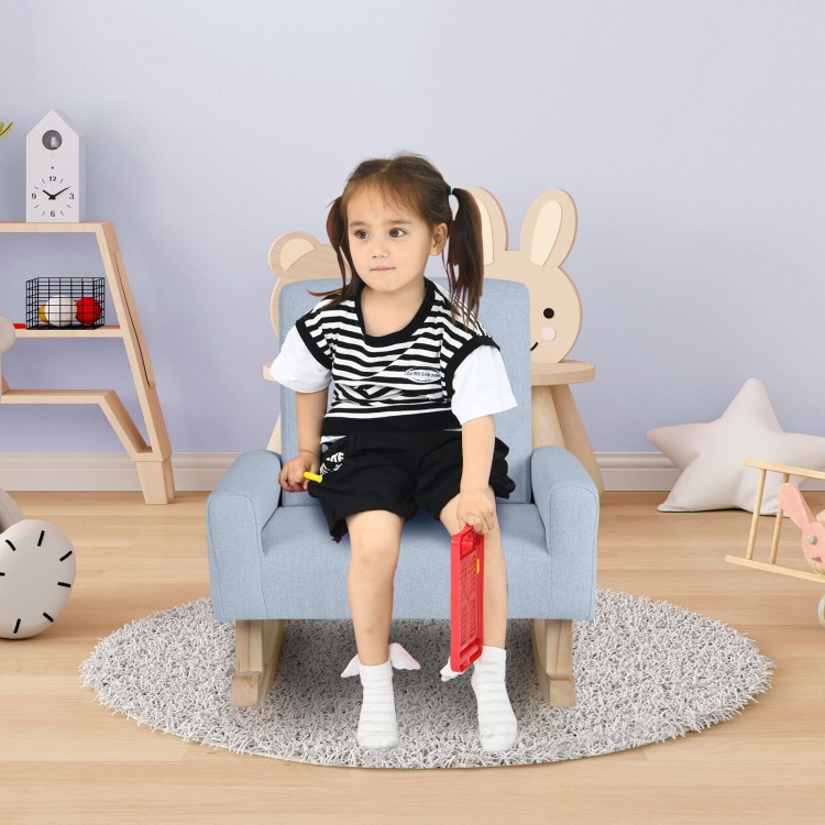 Child sitting comfortably in a blue kids rocking chair with solid wood legs, ideal for reading and relaxing.