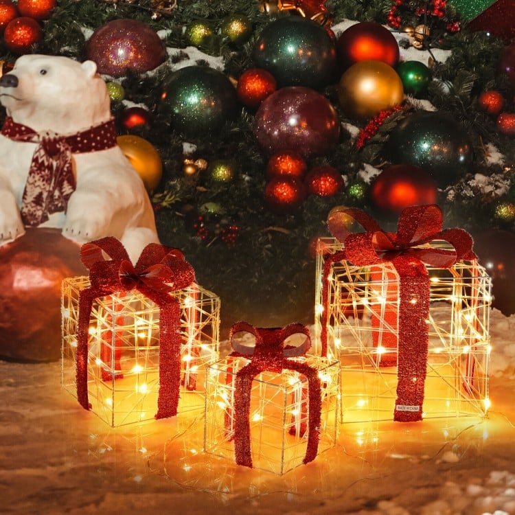Decorative lighted gift boxes with red bows and 60 LED lights, perfect for creating a warm holiday ambiance indoors or.