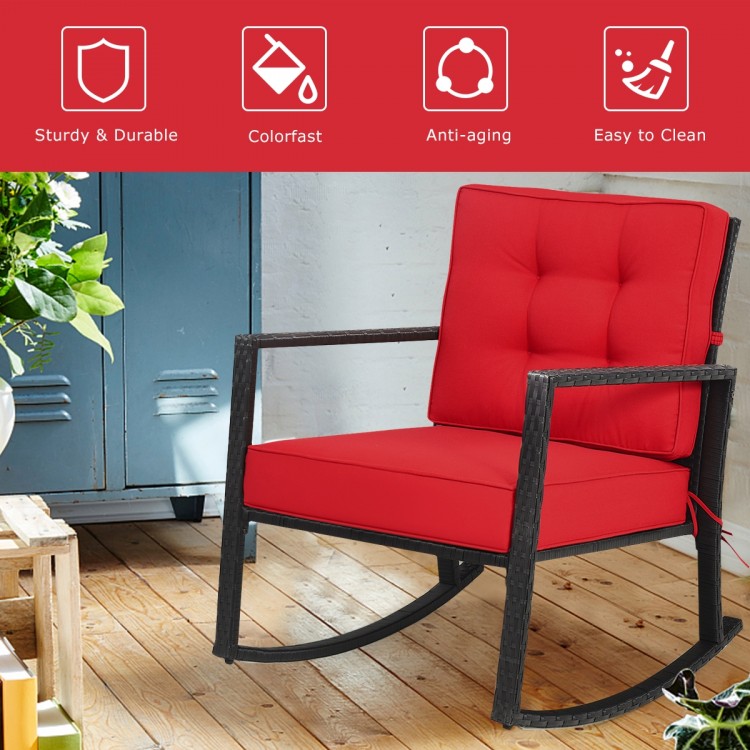 Red patio rattan rocking chair with thick cushions, sturdy metal frame, perfect for outdoor relaxation and comfort.