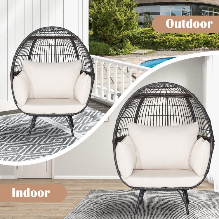Oversized patio rattan egg lounge chair in brown with four cushions, suitable for indoor or outdoor relaxation.