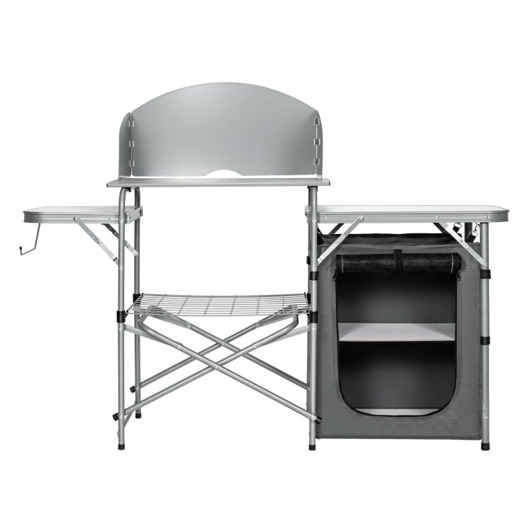 Foldable outdoor BBQ grilling table with a windscreen, featuring a sturdy design and ample storage space for cooking.