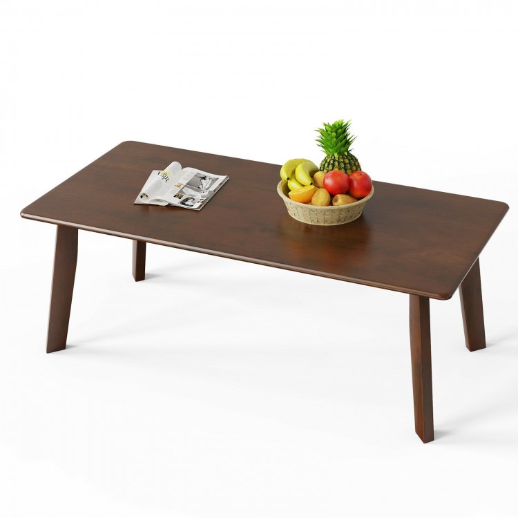 Rectangular wooden coffee table with rubber legs, featuring a large scratch-resistant tabletop, ideal for daily use.