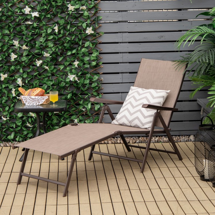 Foldable chaise lounge chair in brown with adjustable footrest, perfect for poolside relaxation or outdoor use.