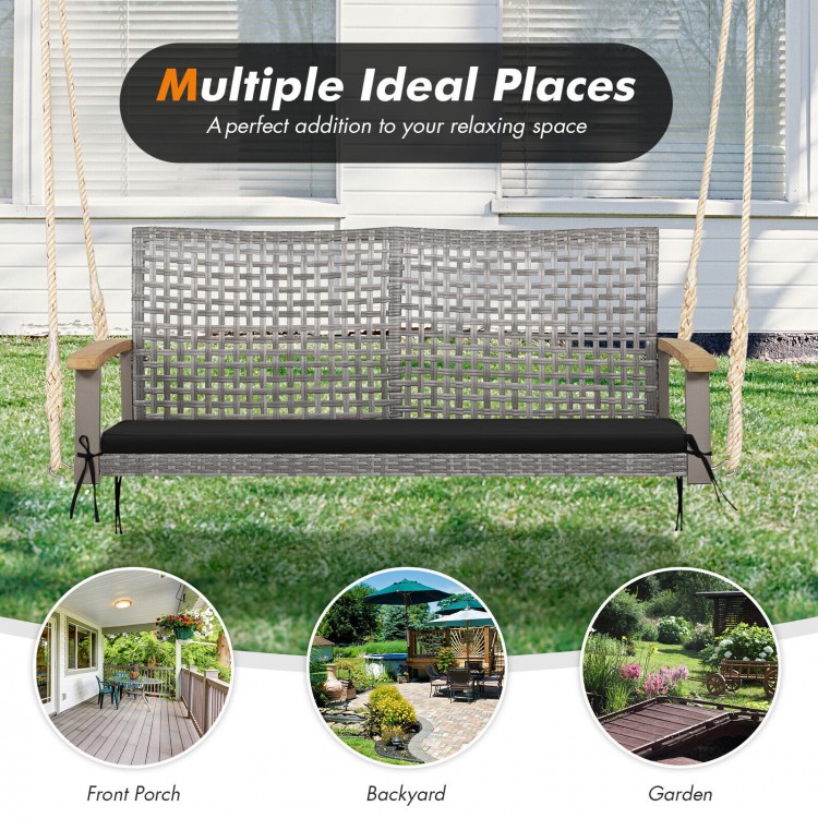 Spacious 2-person patio wicker hanging swing chair with gray PE rattan and acacia wood armrests for outdoor relaxation.
