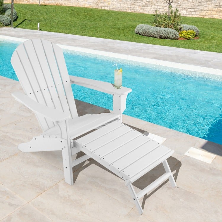 White HDPE Adirondack chair with retractable ottoman, perfect for outdoor relaxation by the poolside.