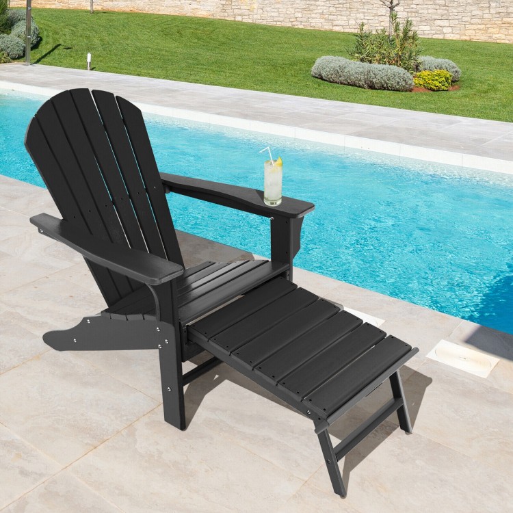 Black HDPE Adirondack chair with retractable ottoman, perfect for outdoor relaxation by the poolside.