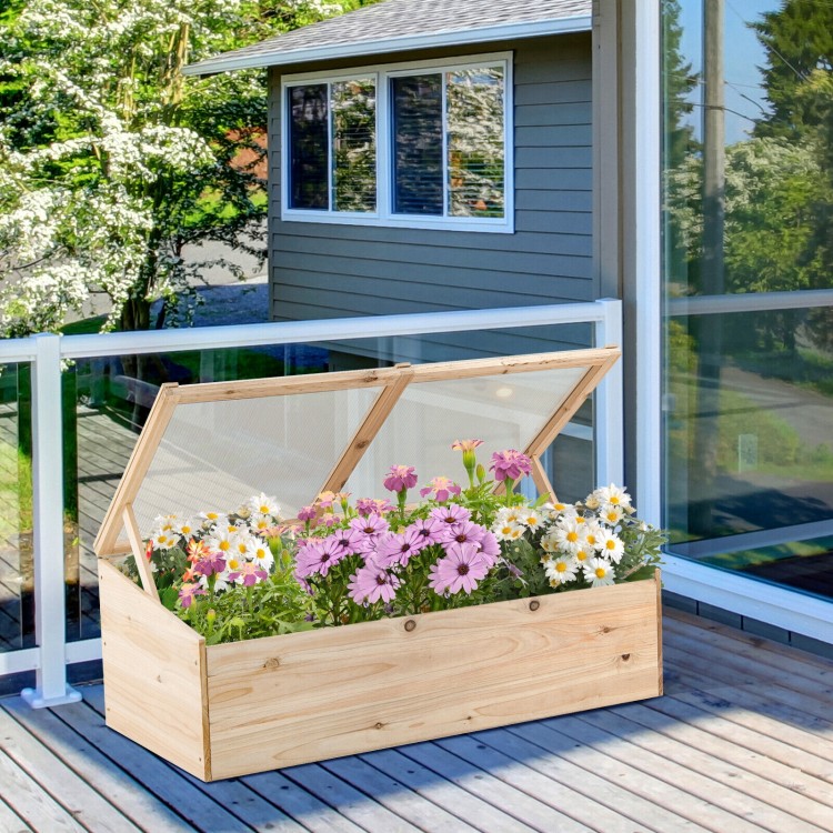 Wooden garden portable greenhouse with transparent PVC lid, filled with colorful flowers, ideal for balcony or terrace.