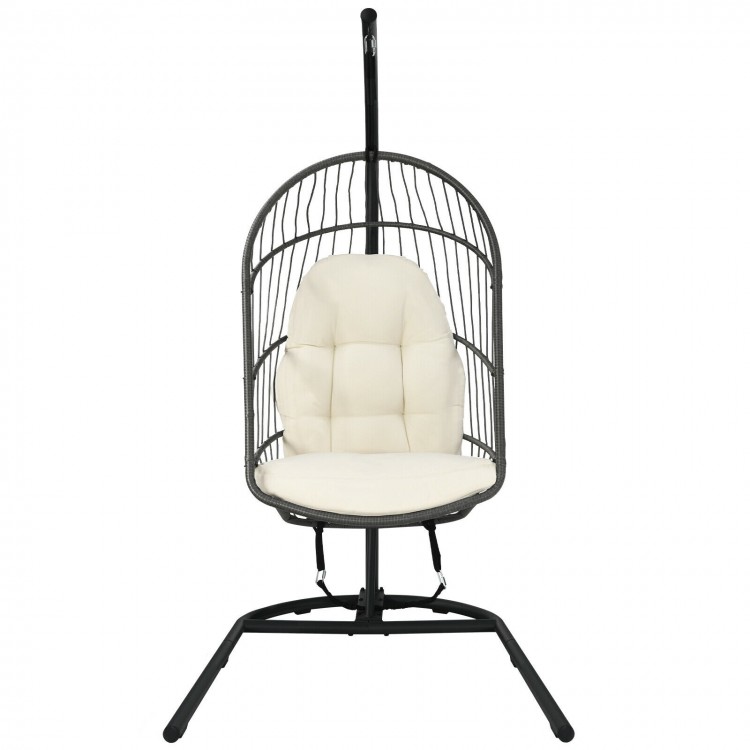 Hanging wicker egg chair with stand in beige, featuring a sturdy steel frame and comfortable cushions for outdoor or.