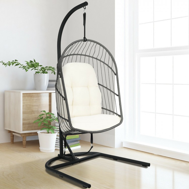 Beige hanging wicker egg chair with stand, made of weather-resistant PE rattan and anti-rust steel frame, ideal for.