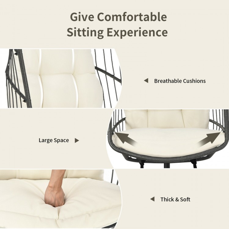 Hanging wicker egg chair with beige cushions, featuring a spacious design for comfort and safety for indoor or outdoor.