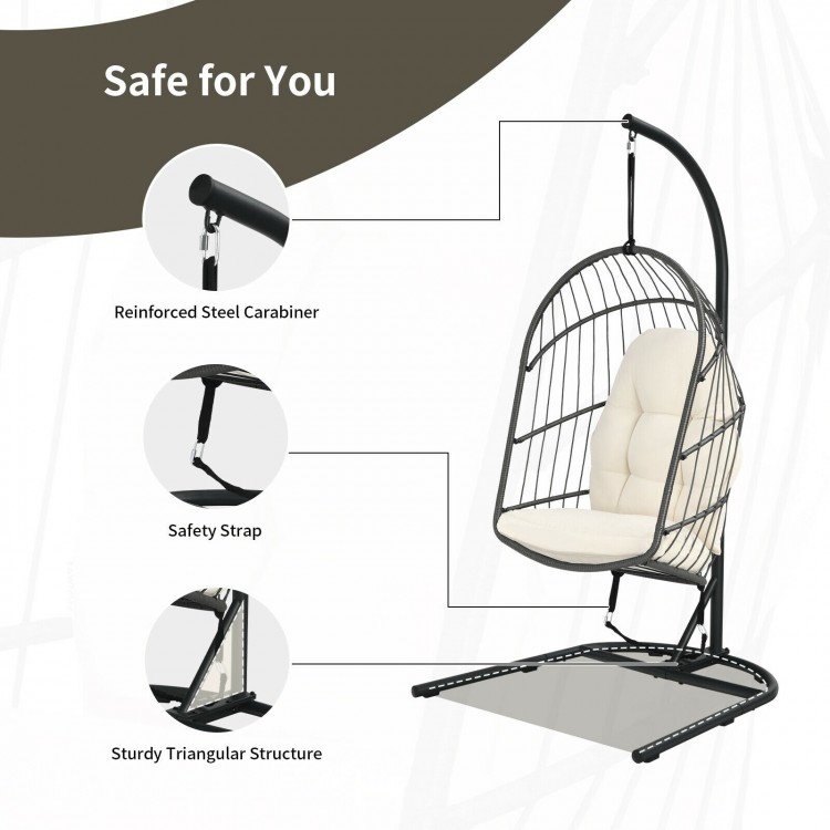 Hanging wicker egg chair with stand, featuring a beige cushion, sturdy triangular structure, and safety strap for.