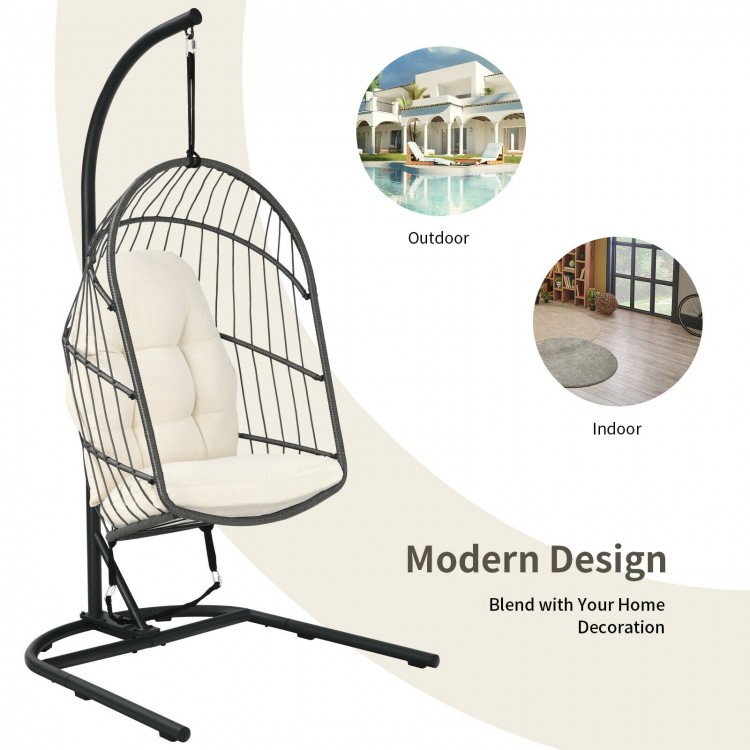 Beige hanging wicker egg chair with stand, showcasing its modern design and anti-slip foot pads for indoor and outdoor.