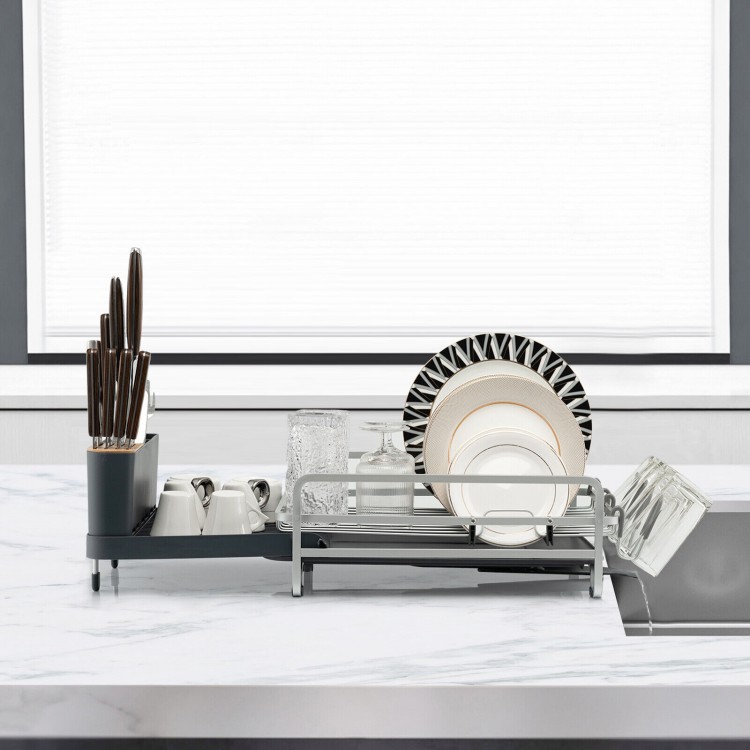 Aluminum expandable dish drying rack with drainboard and swivel spout, organized for cutlery, plates, and glasses.