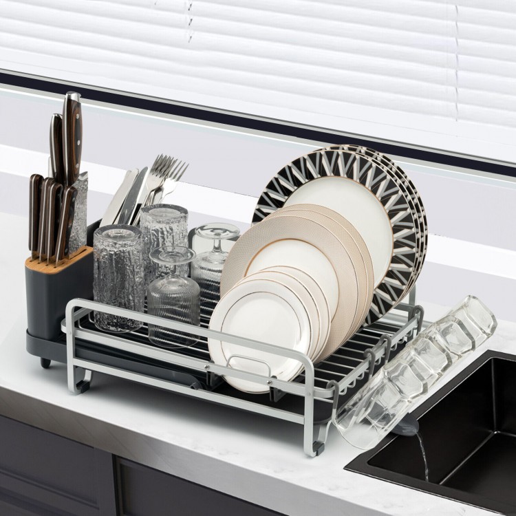Aluminum expandable dish drying rack with drainboard, holding plates, glasses, and cutlery for organized kitchen.