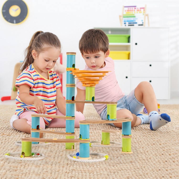 Children playing with the Bamboo Build Run Toy marble set, featuring colorful bamboo pieces for creative engineering.