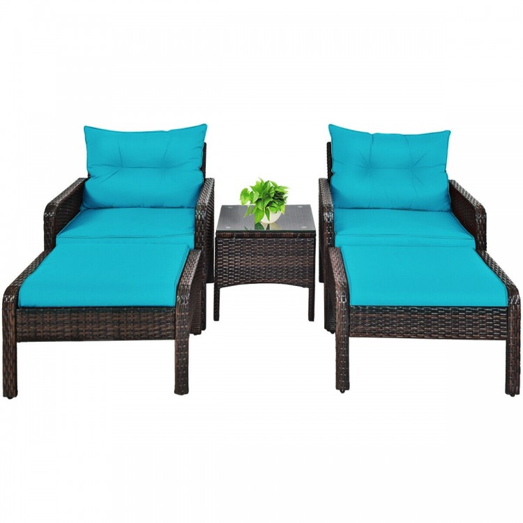 Two turquoise cushioned single sofas and two ottomans with a glass-top tea table, perfect for outdoor patio relaxation.