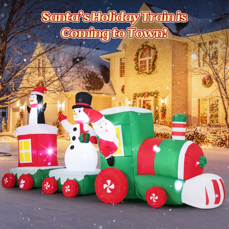 Santa Claus, snowman, and penguin on an 11.5 FT Christmas inflatable train, perfect for outdoor holiday displays.