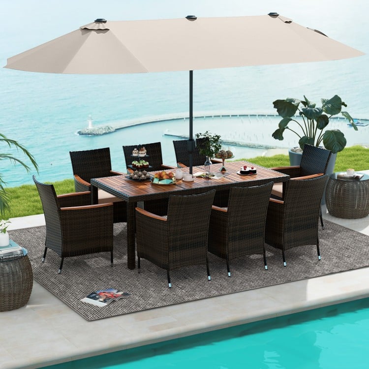 11-piece patio dining set featuring a 15-foot double-sided umbrella, PE rattan chairs, and acacia wood table for.
