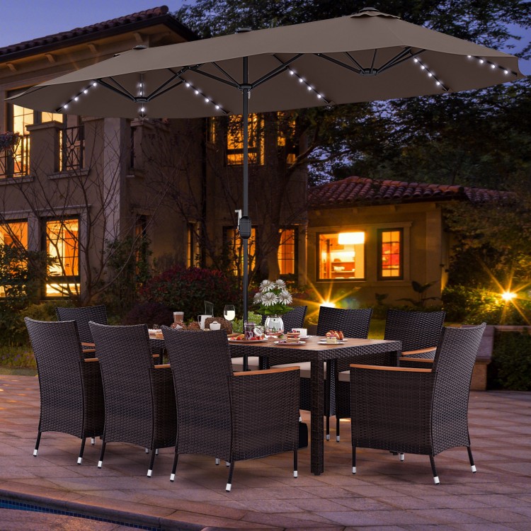 Patio dining set featuring a large acacia wood table, 8 stackable chairs, and a 15 ft double-sided umbrella for outdoor.