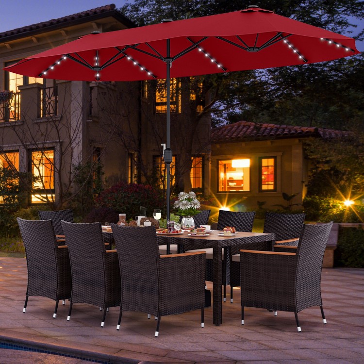 Patio dining set featuring a 15 ft double-sided umbrella, hand-woven PE rattan chairs, and a large acacia wood tabletop.