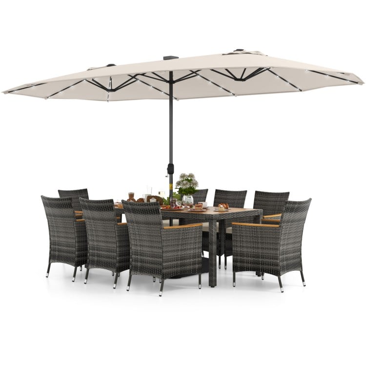 11-piece patio dining set featuring a large acacia wood table, 8 gray PE rattan chairs, and a 15 ft double-sided.
