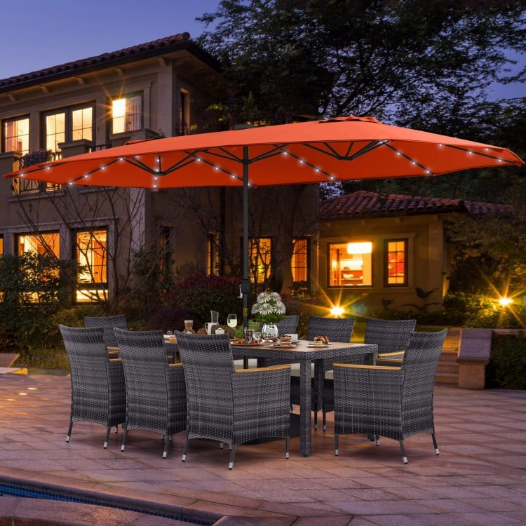 11-piece patio dining set featuring a 15-foot orange umbrella, gray PE rattan chairs, and acacia wood table for outdoor.
