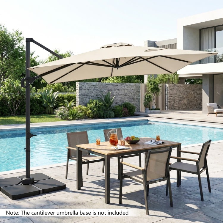 Beige 11 x 9 FT cantilever patio umbrella with 360° rotation, placed by a poolside dining set for outdoor shade.