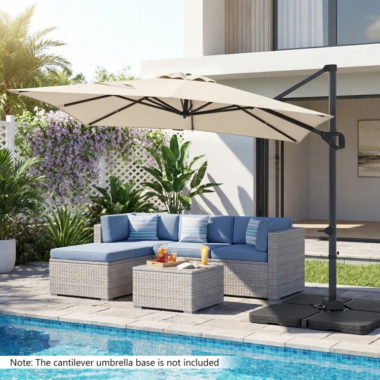 Beige 11 x 9 FT cantilever patio umbrella with 360° rotation, placed by a poolside seating area for outdoor shade.