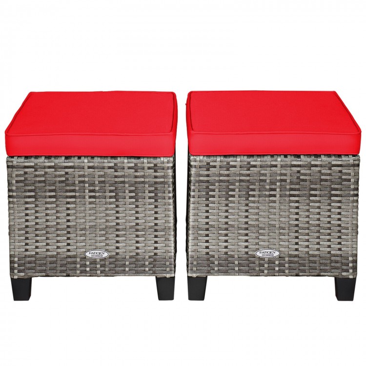 Set of two patio rattan wicker ottomans with removable red cushions, perfect for outdoor use in garden or poolside.