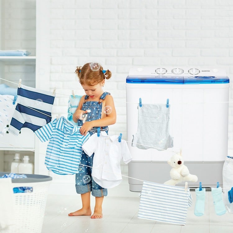 Child playing with clothes near a 2-in-1 portable washing machine, showcasing its compact design and washing features.