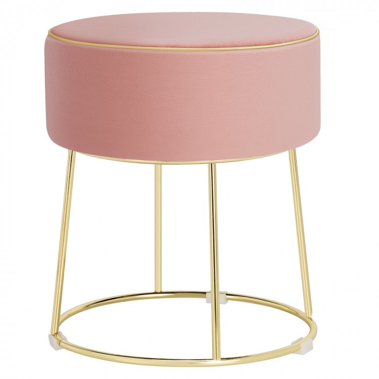 Round pink velvet footrest stool with gold metal frame, ideal for bedside use and versatile home decor.