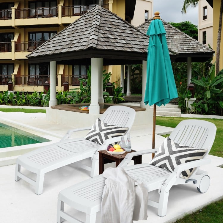 Adjustable white patio sun lounger with wheels, featuring a storage box, perfect for poolside relaxation.