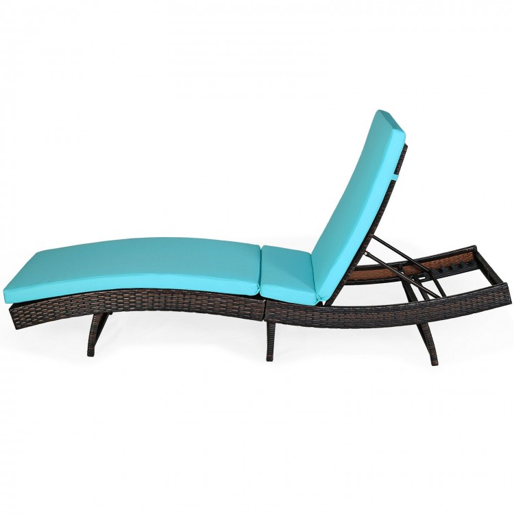 Side view of turquoise folding rattan chaise lounge chair with cushion, featuring a sleek ergonomic design for outdoor.